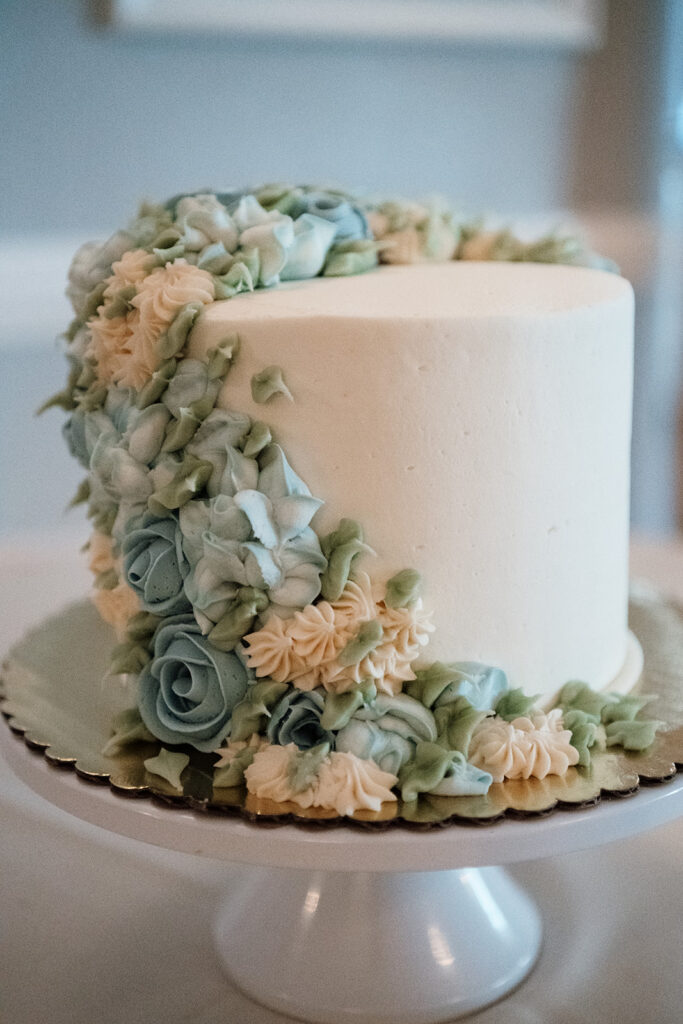 Simple white cake with floral details.