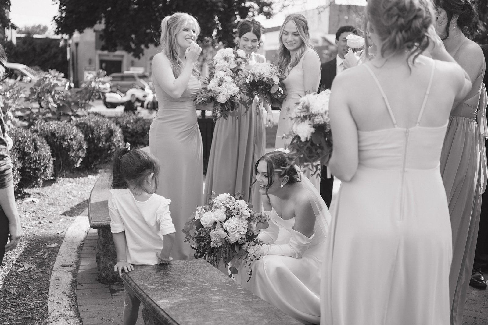 Bride talking to a little girl by the fountain at Kellogg Park in Plymouth, Michigan.