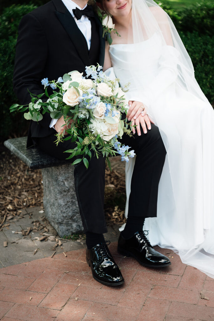 Close up photo of a bride and groom sitting together.