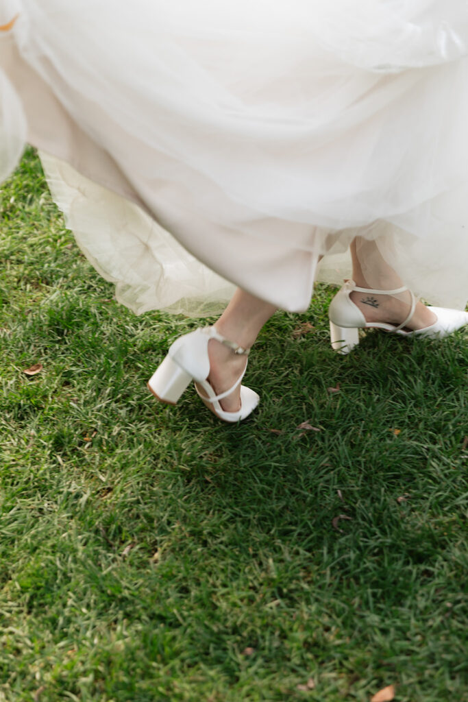 Close up photo of a bride walking in the grass.