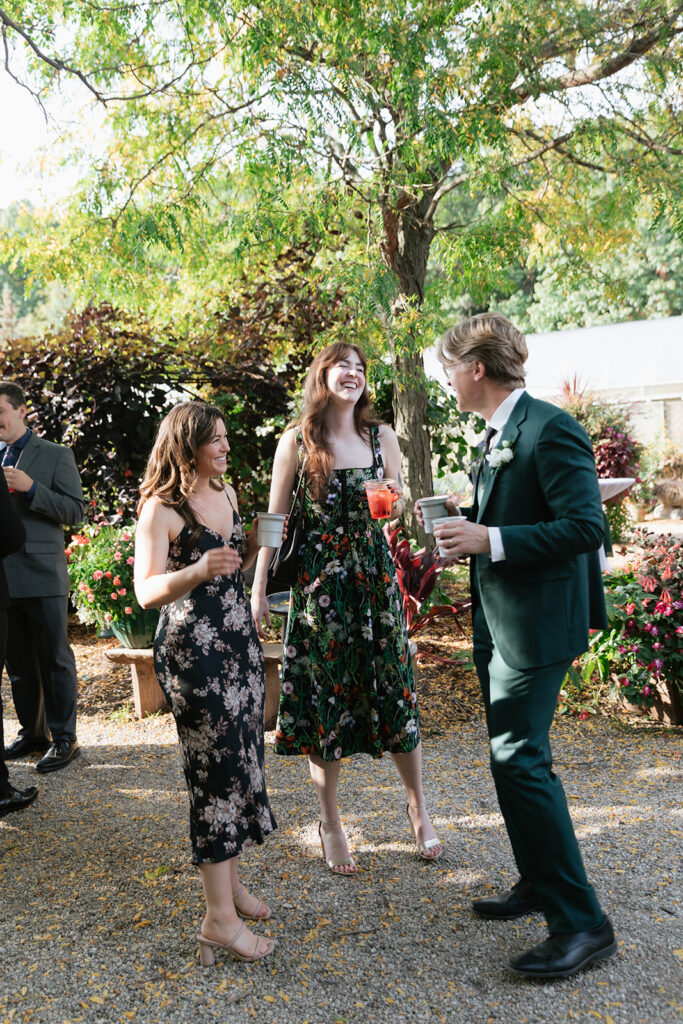 Guests mingling with drinks during cocktail hour.