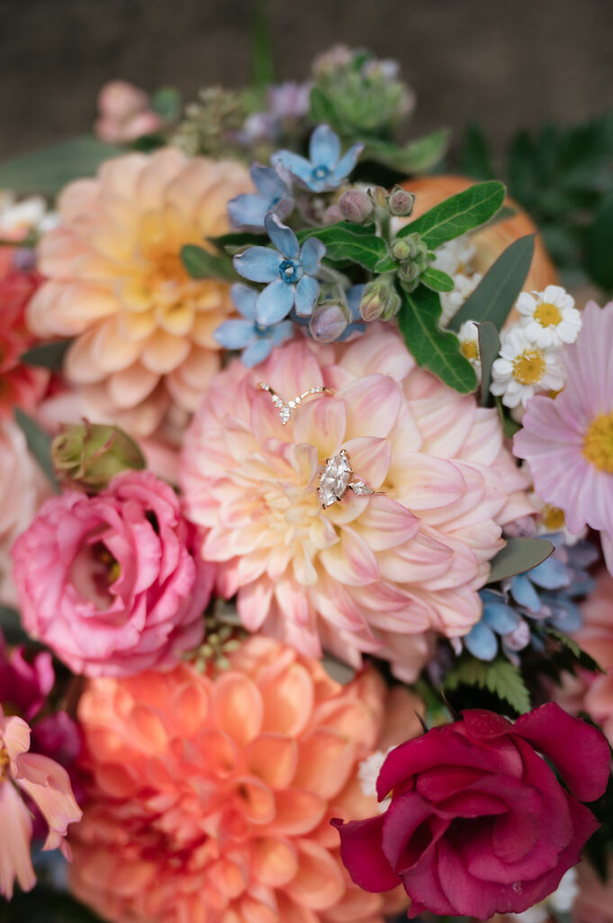 Brides wedding rings styled in flowers.