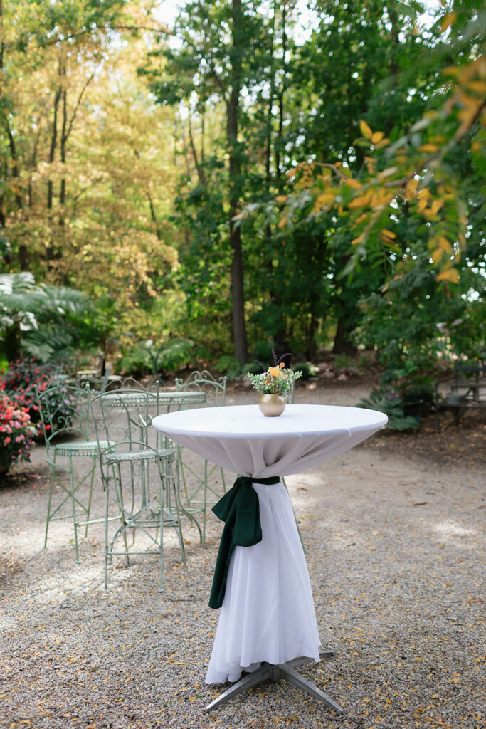 Tables set outdoors for a Everlastings in the Wildwood wedding reception and cocktail hour.