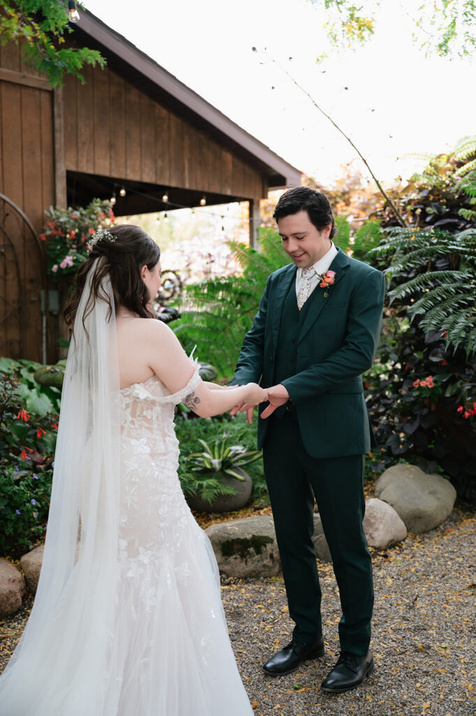 Bride and groom seeing each other during their garden first look at Everlastings in the Wildwood.