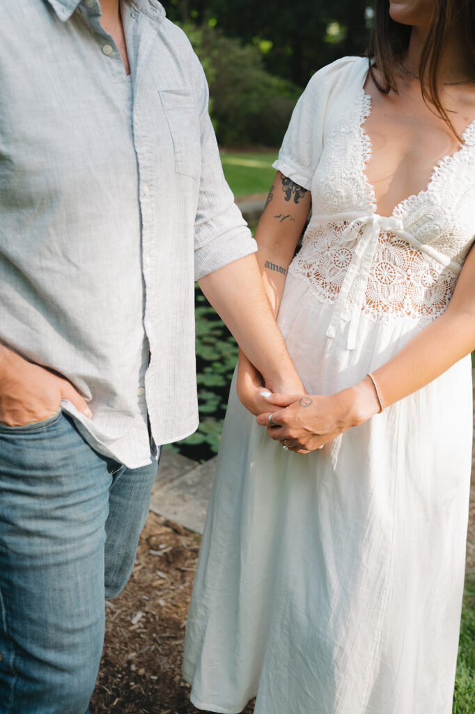 Close up photo of a couple holding hands.