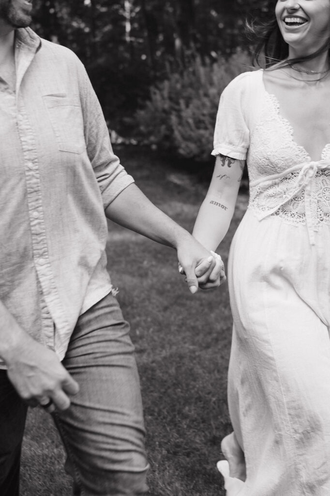 Close up black and white candid photo of a couple walking.