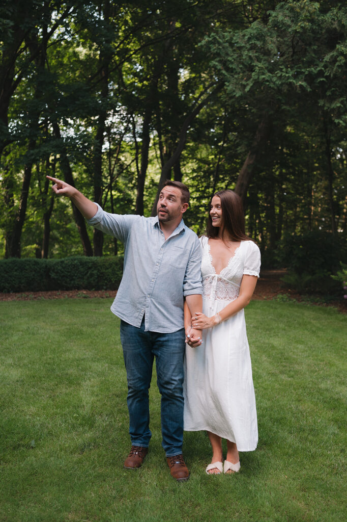 Couple admiring the beauty at Aquinas College for their Grand Rapids engagement photos.