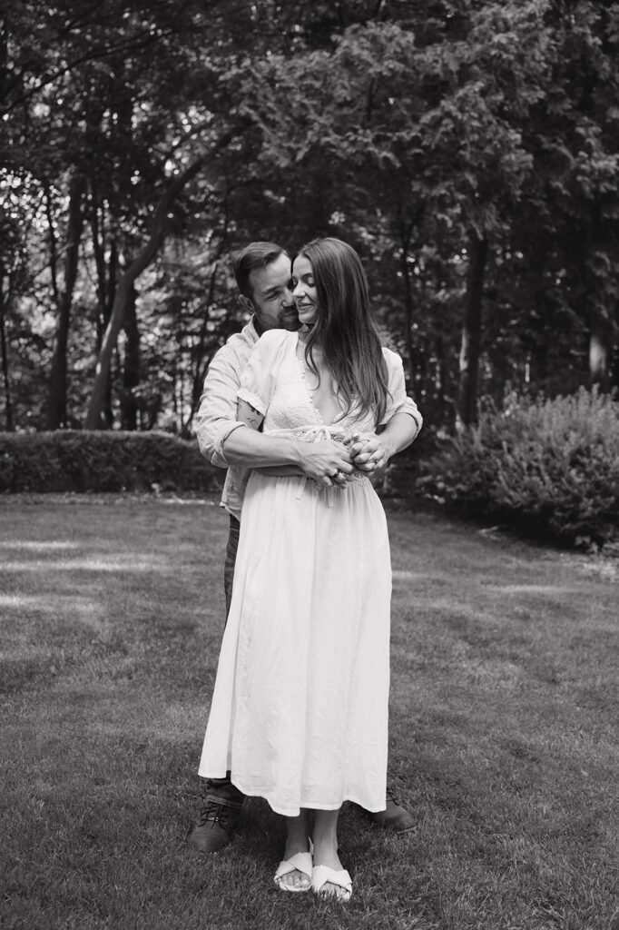 Black and white photo of a couple holding each other for their Grand Rapids engagement photos.