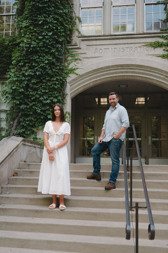 Couple posing on the stairs at Aquinas College.