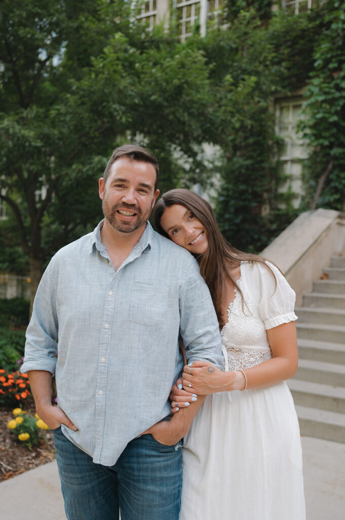 Woman resting her head on her fiancés shoulders during their summer engagement photos.