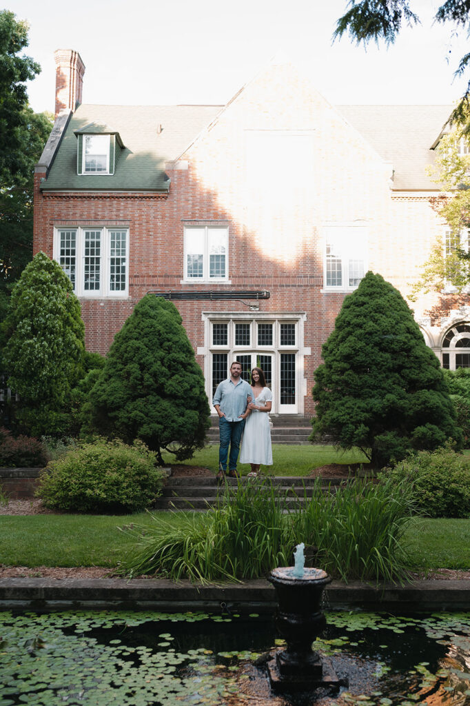 Couple posing in front of a building at Aquinas College.