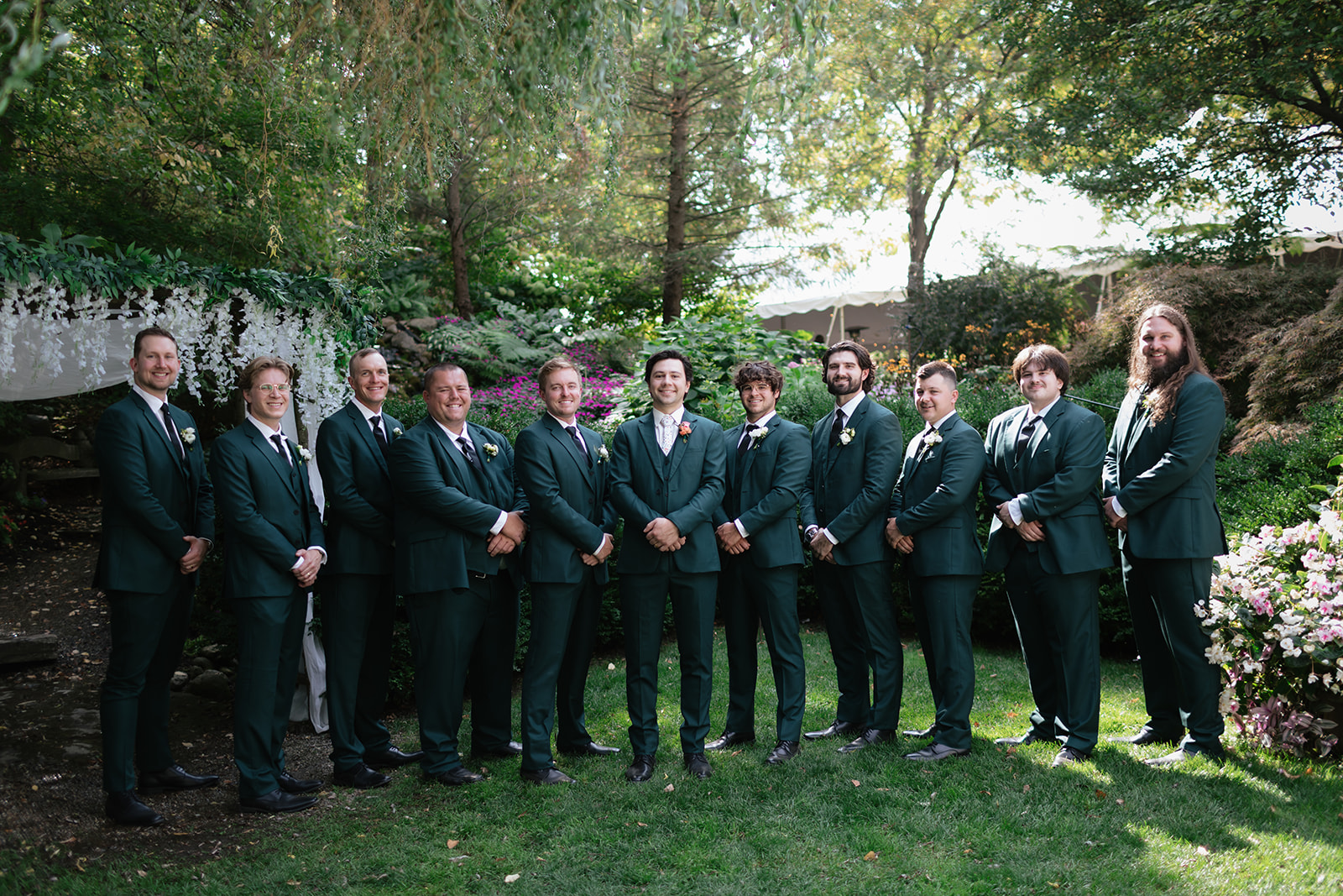 Outdoor groom and groomsmen photos from a Everlastings in the Wildwood wedding in Owosso, Michigan.