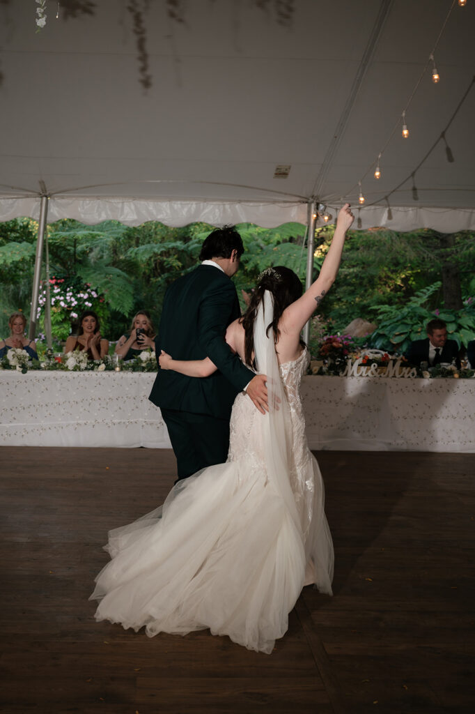 Bride and groom walking off the dance floor after their first dance.