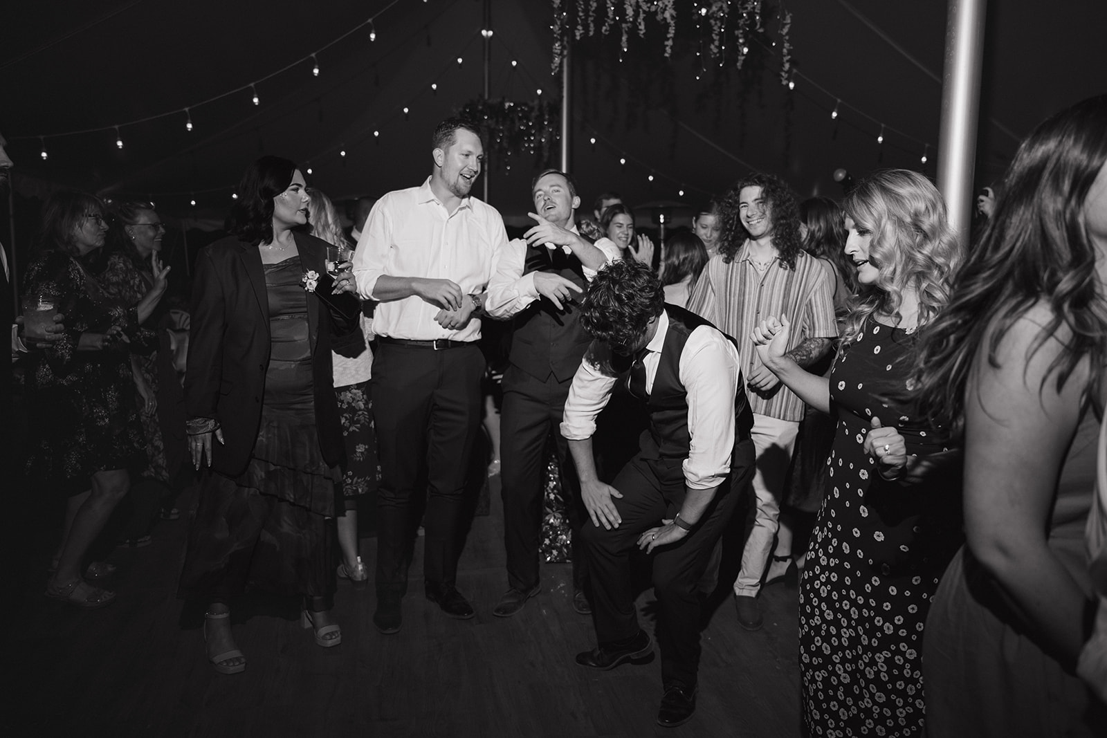 Black and white photo of guests dancing on the dance floor. 