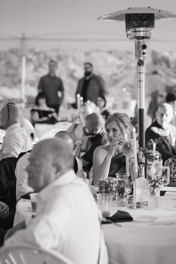 Black and white photo of guests listening to speeches.