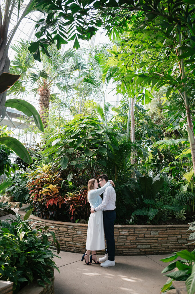 Couple posing inside The Conservatory for their Belle Isle engagement photos in Detroit. 