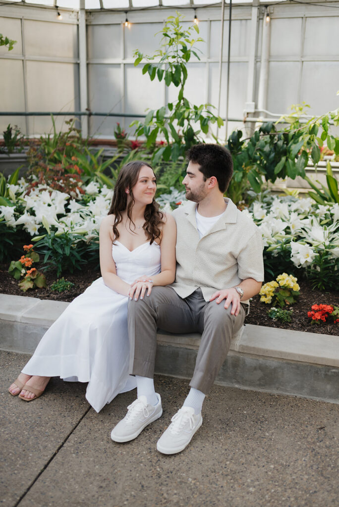 Couple posing inside The Conservatory for their Belle Isle engagement photos in Detroit. 