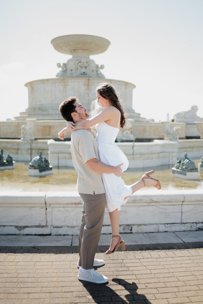 Couple posing in front of the water fountain at Belle Isle for their Detroit engagement photos. 