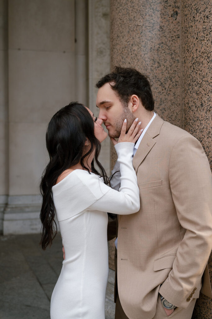 Couple kissing during their Detroit engagement photos.