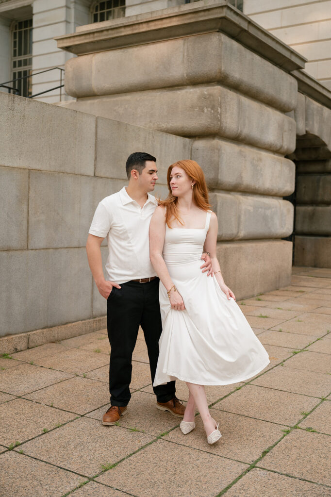 Couple posing outside of the courthouse for their Detroit engagement photos.