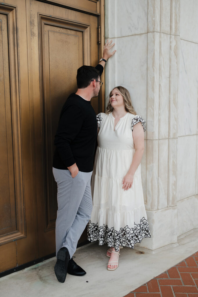 Couple posing for their Detroit engagement photos at The Detroit Institute of Arts. 