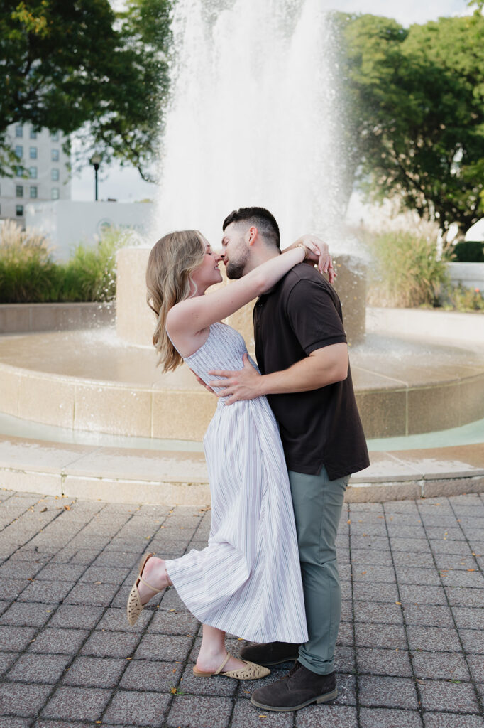 Couple kissing in front of a water tower outside of The Detroit Institute of Arts. 