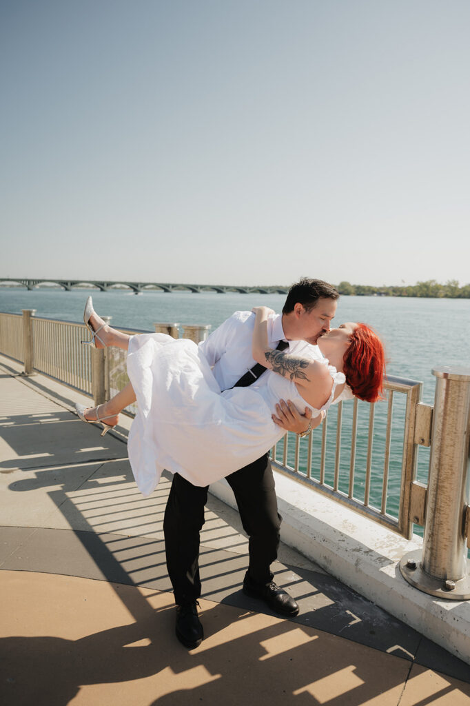 Couple kissing during their Detroit engagement photo on The Riverwalk. 
