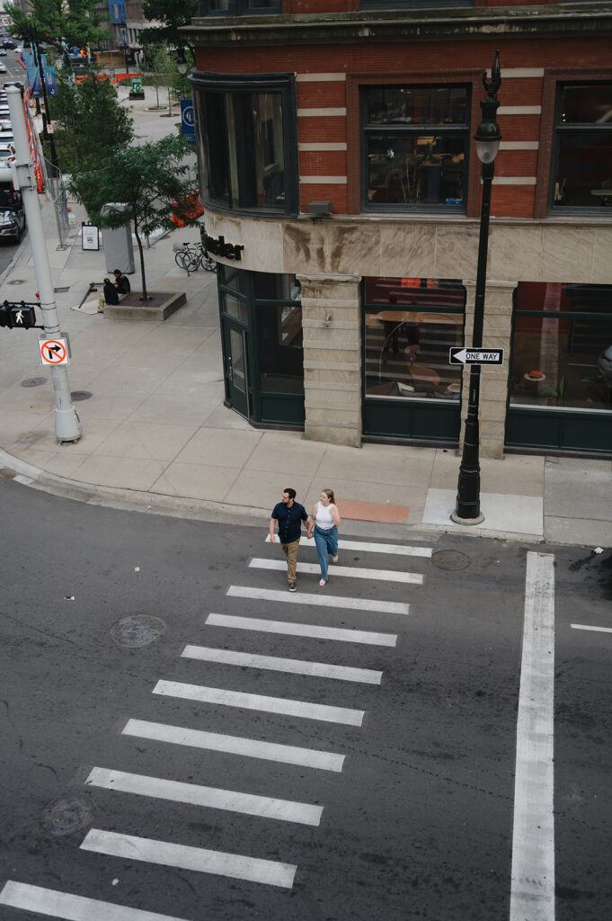 Overhead shot of a couple walking across the street. 