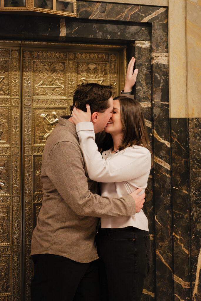 Couple kissing inside Fisher Building for their Detroit engagement photos.