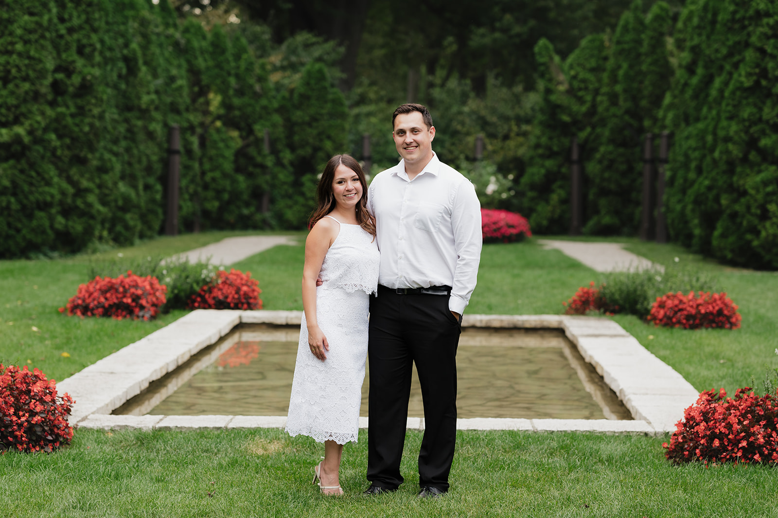 Couple posing in the gardens for their Ford House engagement photos in Grosse Pointe Shores, Michigan.
