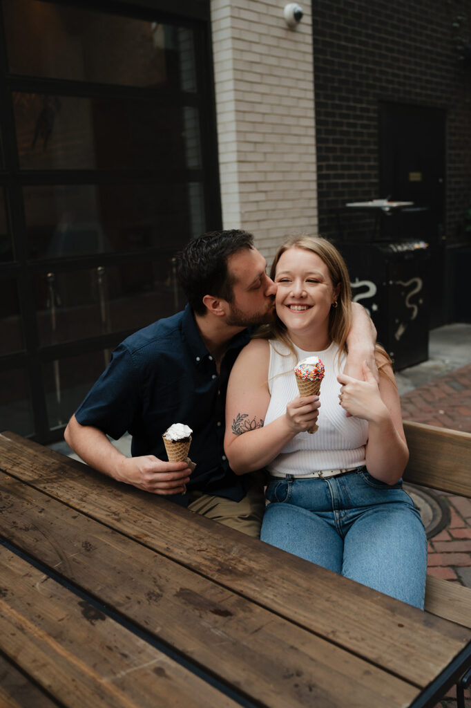 Couple having ice cream from Huddle Soft Serve during their Detroit engagement photos.