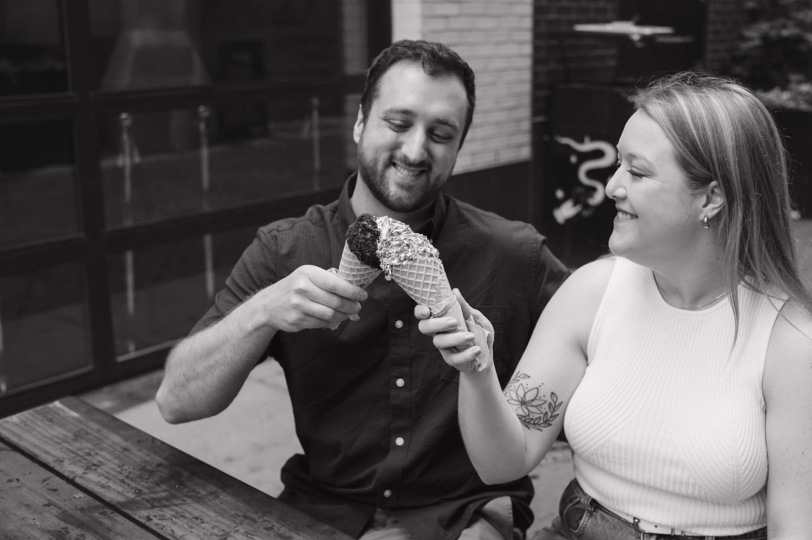 Couple having ice cream from Huddle Soft Serve during their Detroit engagement photos.
