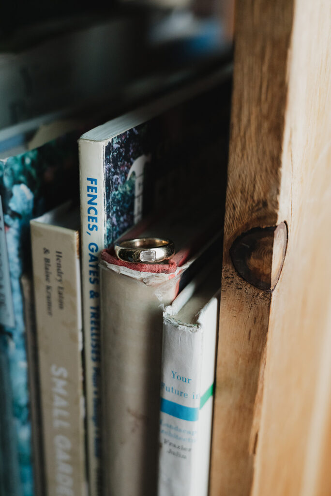 Engagement ring detail shot styled on top of books at John K. King Used & Rare Books