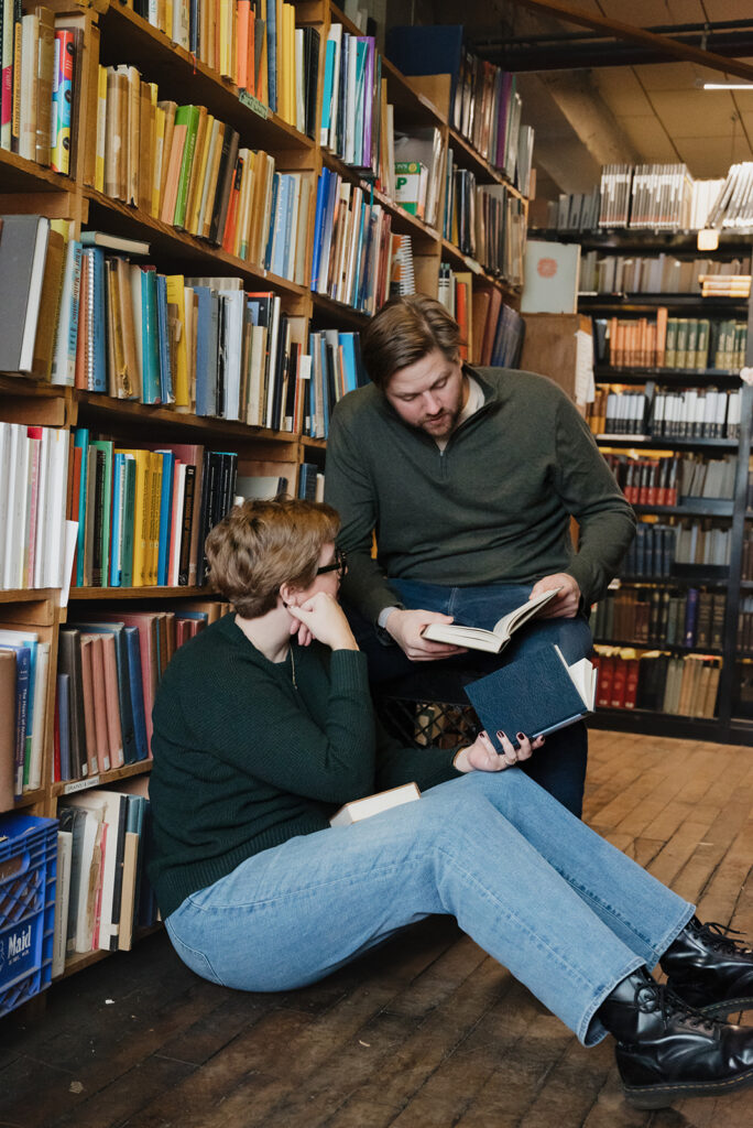 Couple reading during their Detroit engagement photos at John K. King Used & Rare Books.