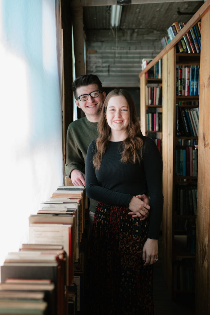 Couple posing for their Detroit engagement photos at John K. King Used & Rare Books