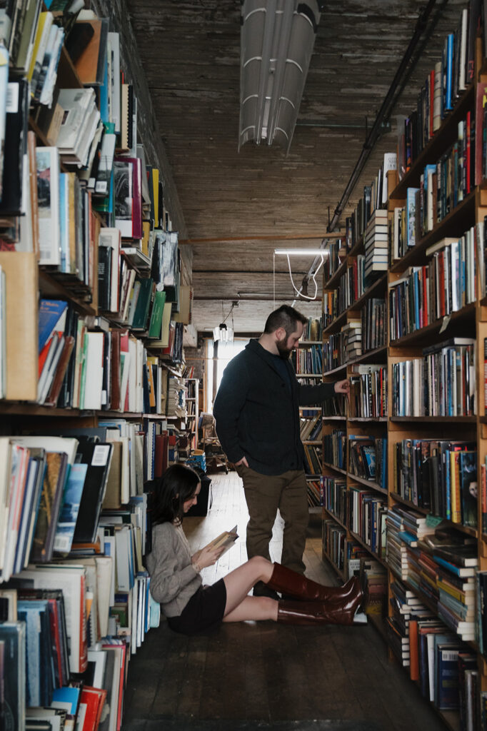 Couple reading in the aisles at John K. King Used & Rare Books