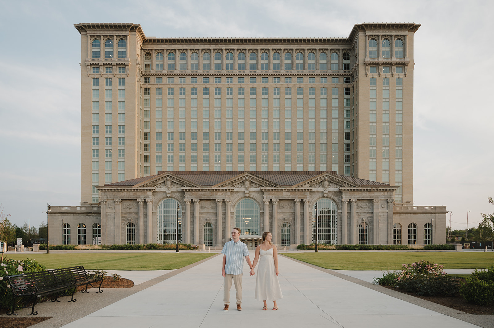 Couple posing outside of Michigan Central Station for their Detroit engagement photos.
