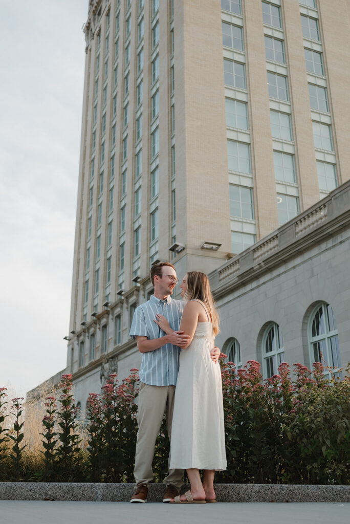 Couple posing outside of Michigan Central Station for their Detroit engagement photos.