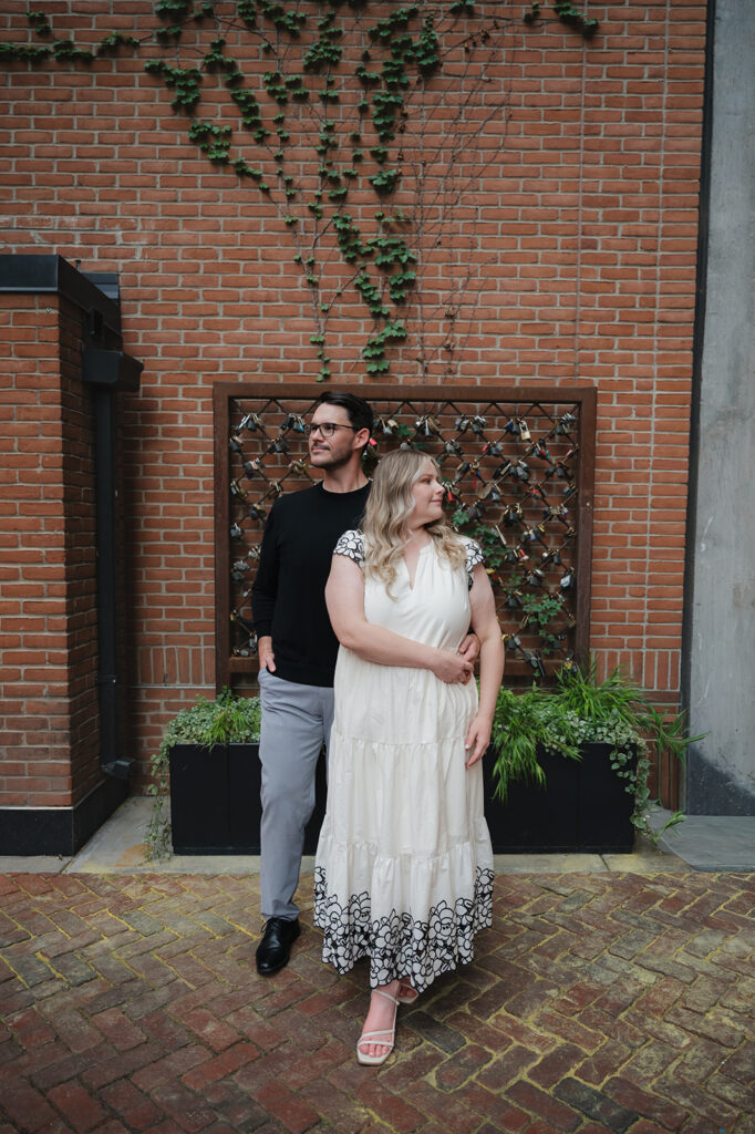Couple posing in Parkers Alley for their Detroit engagement photos.