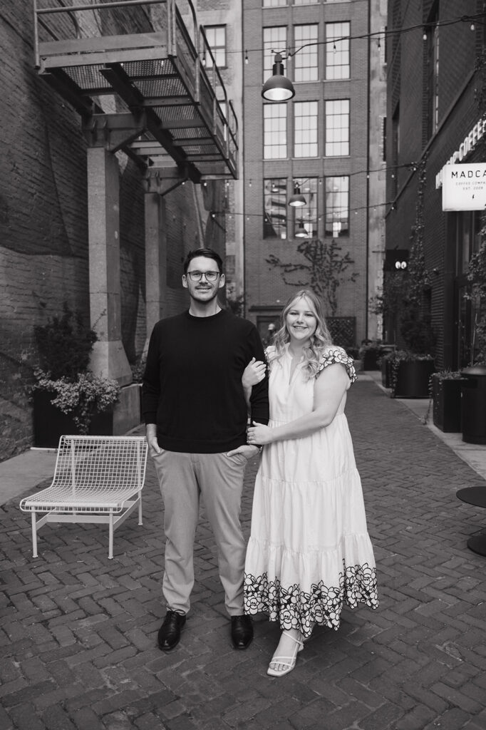 Couple posing in Parkers Alley for their Detroit engagement photos.