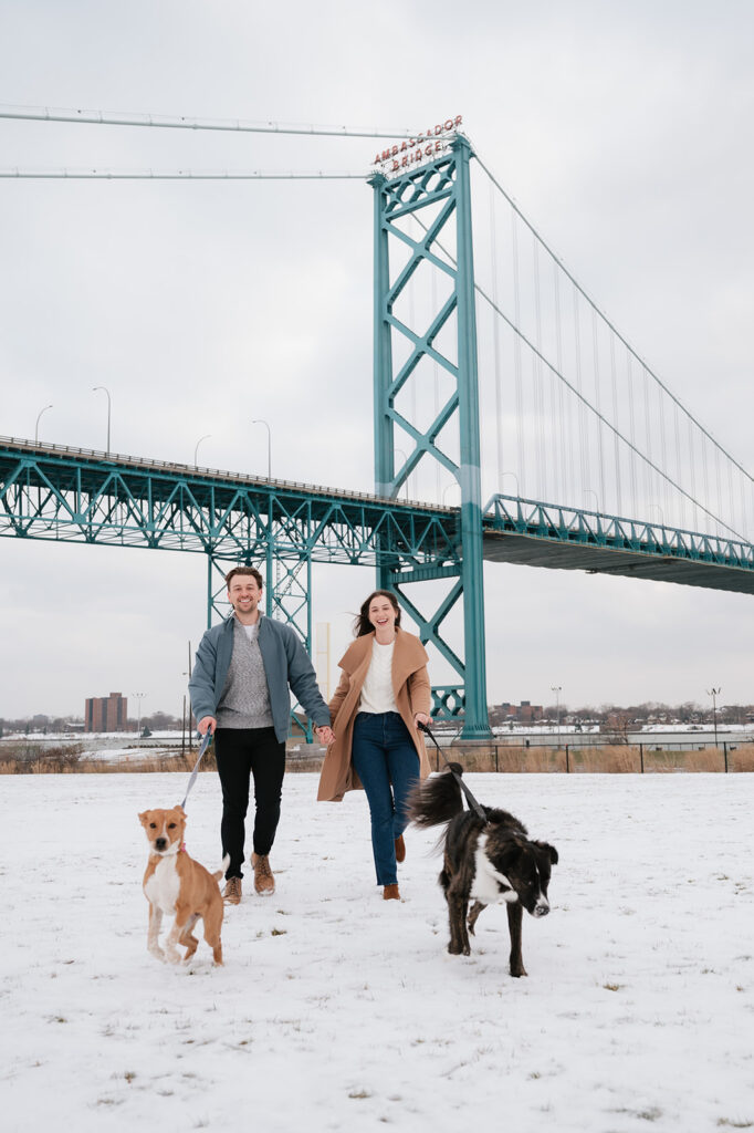 Winter engagement photos in Detroit with Ambassador Bridge in the background. 