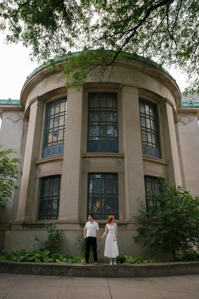 Couple posing outside of Skillman Library for their Detroit engagement photos.
