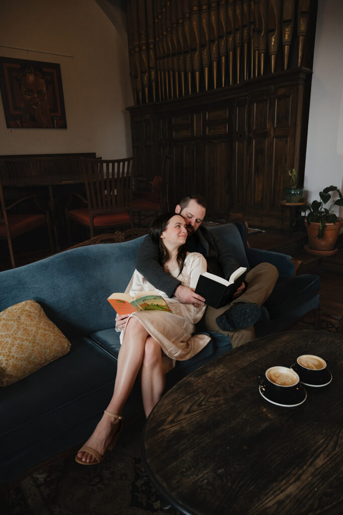 Couple reading books during their Detroit engagement photos inside The Congregation. 